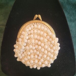 Vintage white beaded crochet coin purse featuring a gold-tone kiss lock